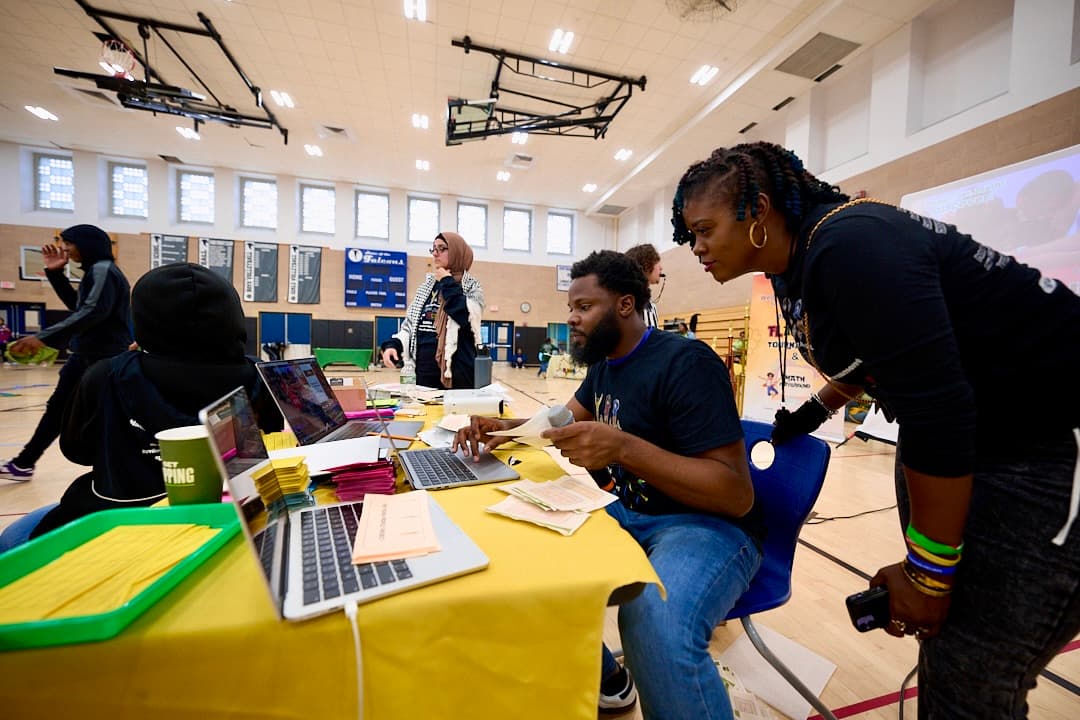people sitting at table with computer